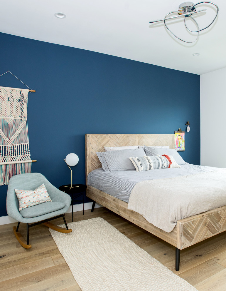 This is an example of a beach style bedroom in San Francisco with light hardwood floors.