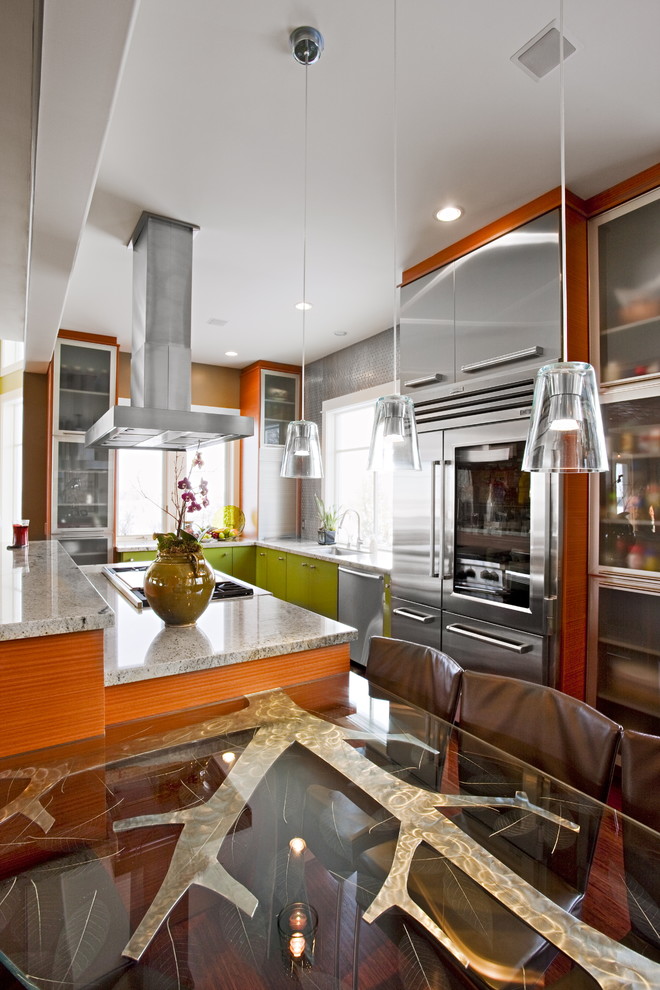 This is an example of a mid-sized contemporary l-shaped open plan kitchen in Salt Lake City with stainless steel appliances, green cabinets, flat-panel cabinets, an undermount sink, metallic splashback, with island and medium hardwood floors.