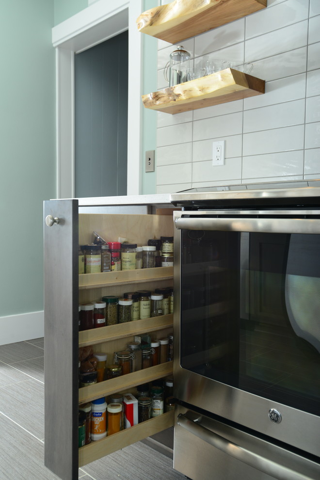 Eat-in kitchen - mid-sized transitional galley vinyl floor eat-in kitchen idea in Seattle with an undermount sink, shaker cabinets, white cabinets, quartz countertops, white backsplash, ceramic backsplash, stainless steel appliances and no island