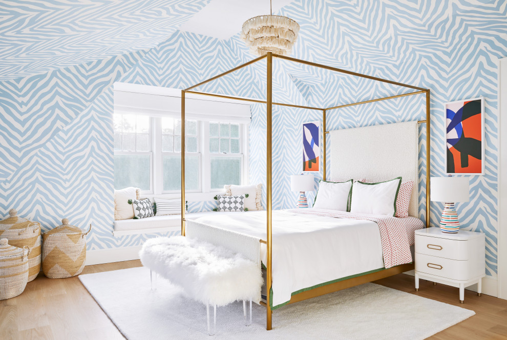 Design ideas for a mid-sized beach style kids' bedroom for kids 4-10 years old and girls in New York with light hardwood floors, blue walls, beige floor, vaulted, wallpaper and wallpaper.