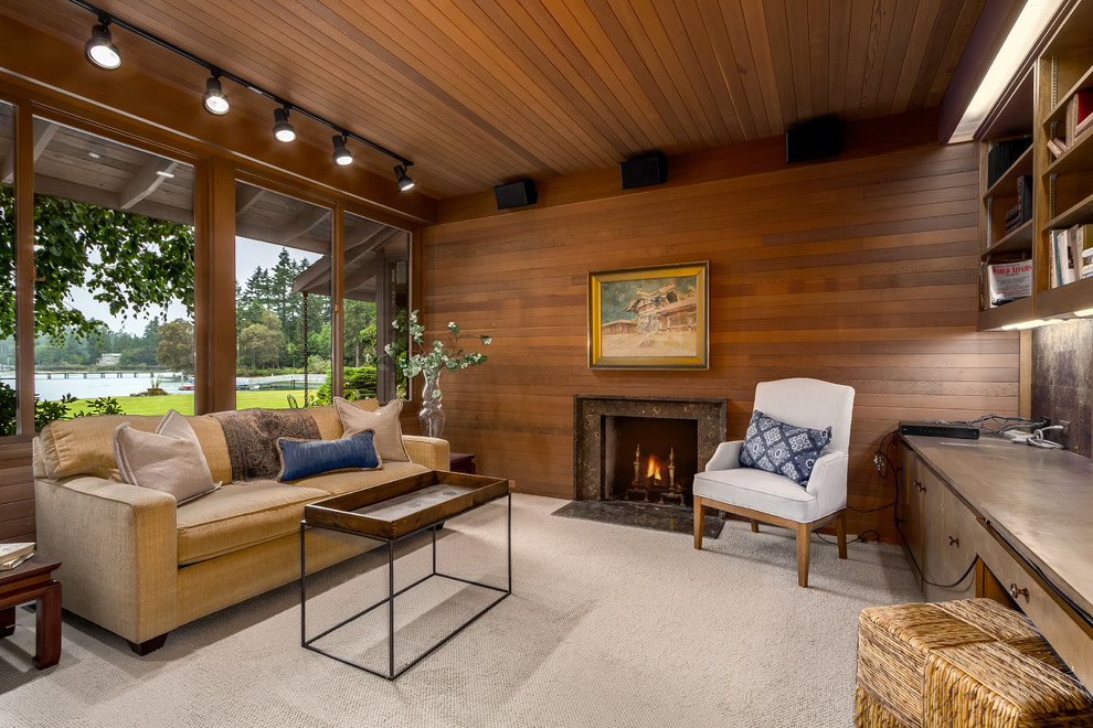Inspiration for a large midcentury living room in Seattle with carpet, a standard fireplace, a stone fireplace surround, beige floor and brown walls.