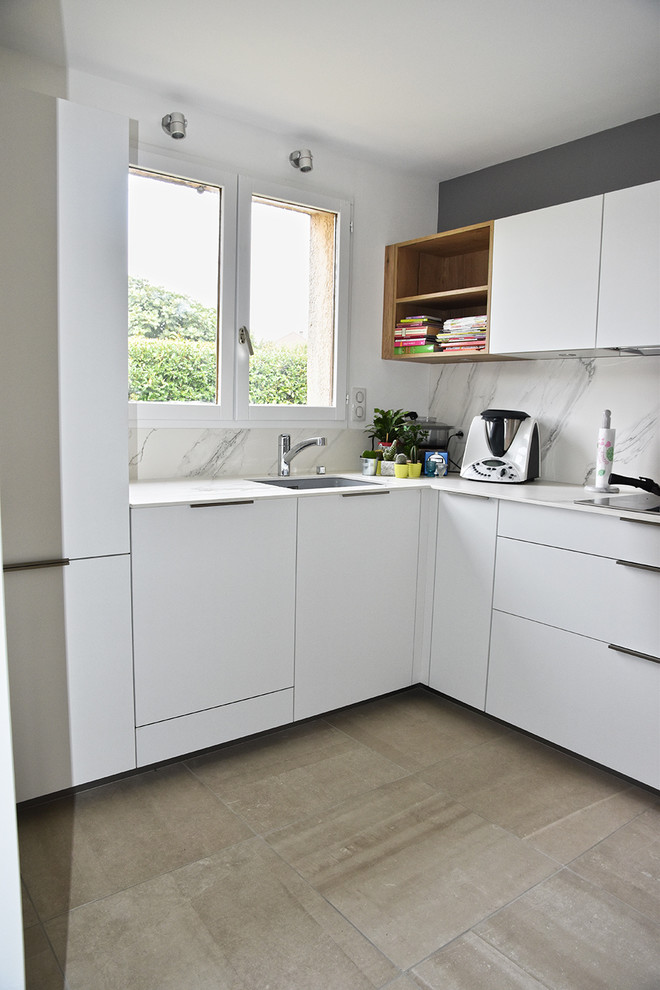 Photo of a mid-sized modern u-shaped separate kitchen in Lyon with an integrated sink, beaded inset cabinets, white cabinets, tile benchtops, white splashback, ceramic splashback, stainless steel appliances, ceramic floors and grey floor.