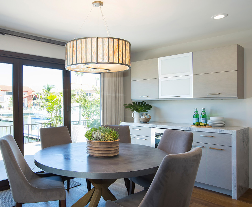 This is an example of a mid-sized contemporary kitchen/dining combo in San Diego with grey walls and medium hardwood floors.