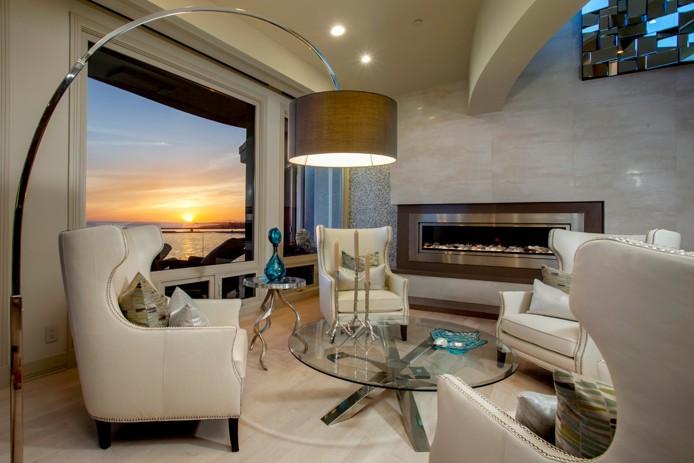 Inspiration for a contemporary enclosed living room in Orange County with beige walls, light hardwood floors, a ribbon fireplace, a metal fireplace surround and no tv.