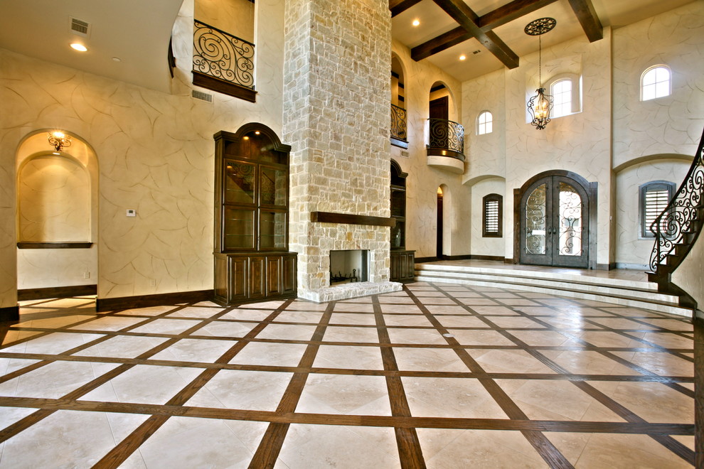 Photo of a large mediterranean formal open concept living room in Dallas with beige walls, ceramic floors, a standard fireplace and a stone fireplace surround.