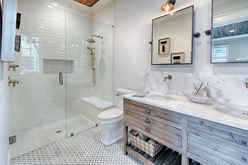 Inspiration for a cottage 3/4 white tile multicolored floor bathroom remodel in Other with medium tone wood cabinets, white walls, an undermount sink, a hinged shower door, a niche and flat-panel cabinets