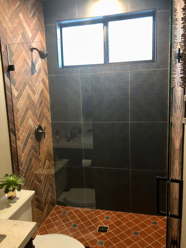 Design ideas for a small country 3/4 bathroom in San Diego with recessed-panel cabinets, brown cabinets, an open shower, a two-piece toilet, blue tile, terra-cotta tile, beige walls, terra-cotta floors, an undermount sink, red floor and a hinged shower door.