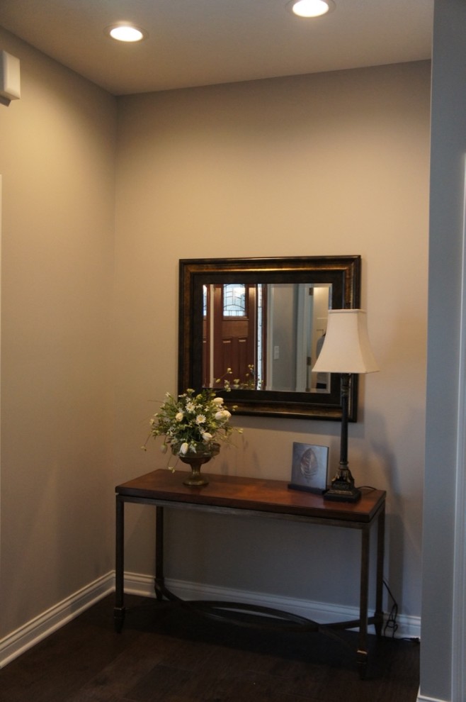 Inspiration for a transitional dark wood floor foyer remodel with beige walls