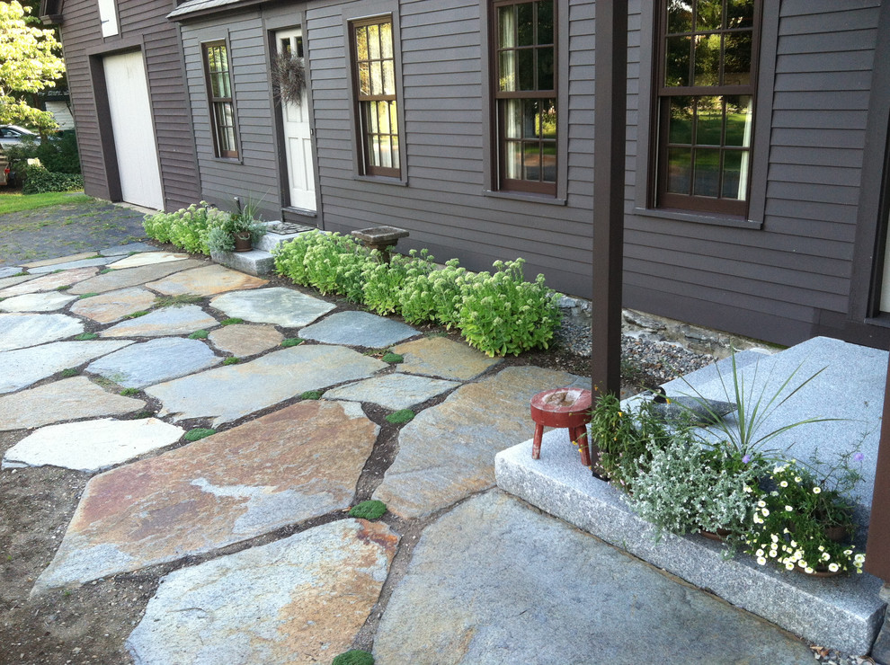 Photo of a mid-sized country front yard full sun driveway for spring in Boston with natural stone pavers and a garden path.