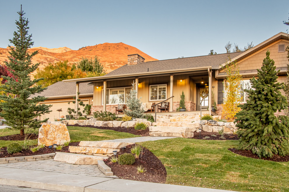 Small traditional front yard full sun garden in Salt Lake City with with path and natural stone pavers for summer.
