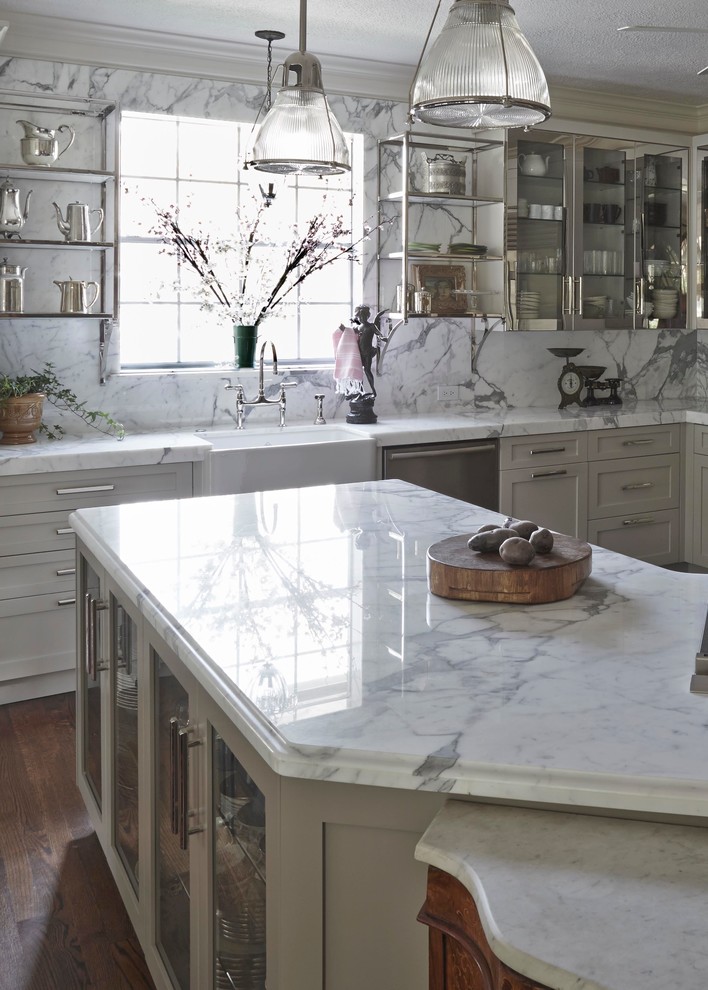 Large transitional l-shaped medium tone wood floor open concept kitchen photo in Houston with a farmhouse sink, shaker cabinets, gray cabinets, marble countertops, gray backsplash, stone slab backsplash, stainless steel appliances and an island