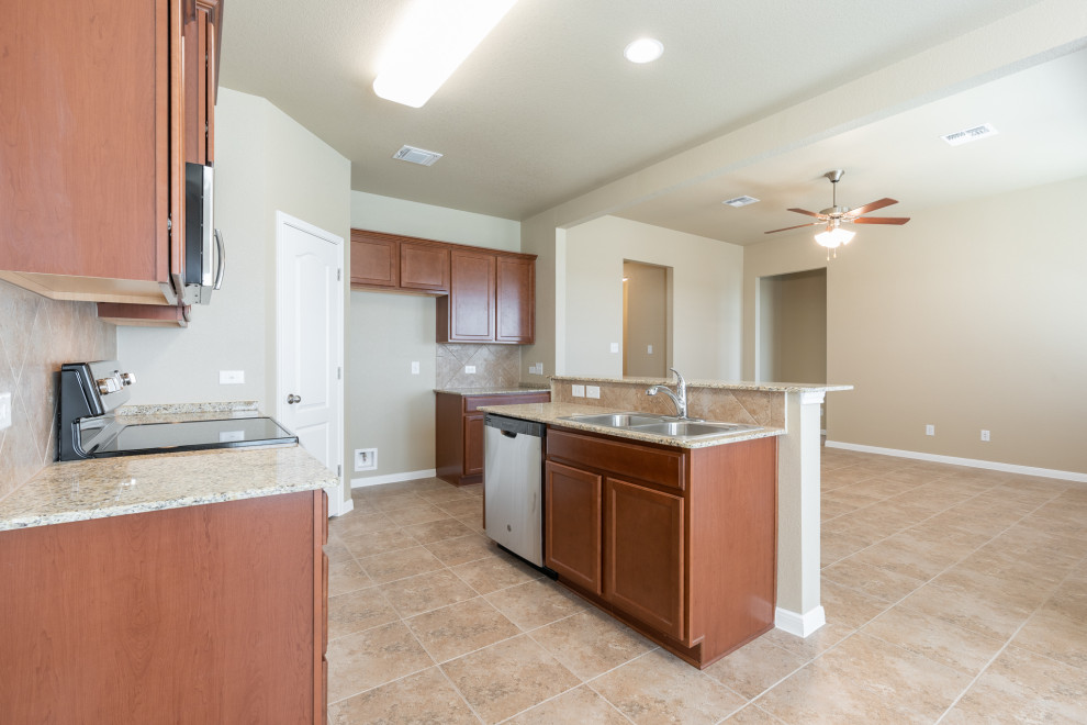 Transitional ceramic tile and beige floor eat-in kitchen photo in Austin with a drop-in sink, raised-panel cabinets, medium tone wood cabinets, granite countertops, brown backsplash, ceramic backsplash, stainless steel appliances, a peninsula and beige countertops