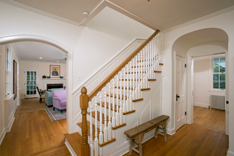 Photo of a mid-sized traditional wood straight staircase in DC Metro with painted wood risers.