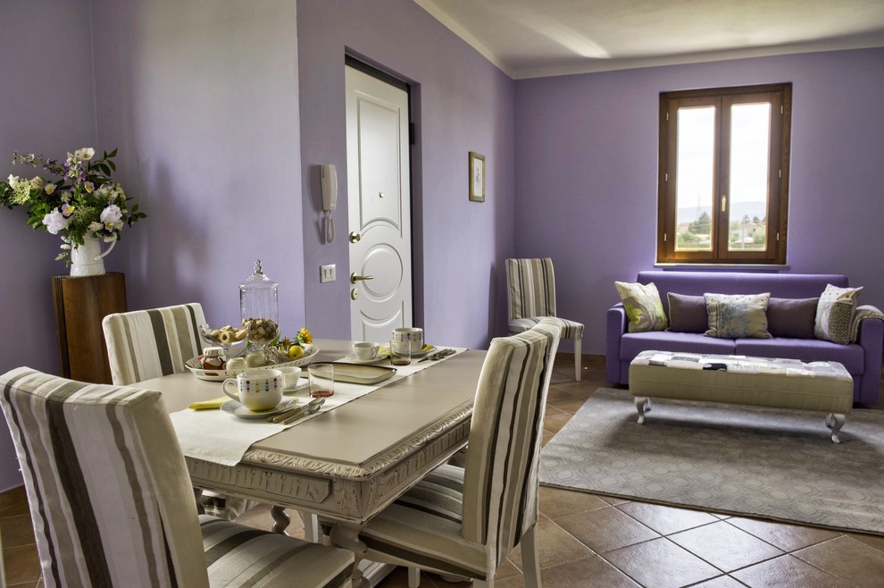 Inspiration for a traditional dining room in Rome with purple walls.