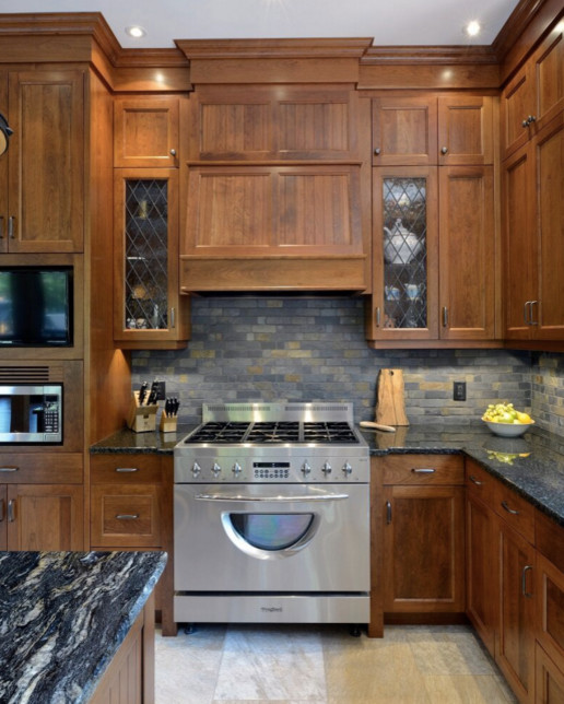 Photo of a large country galley open plan kitchen in Boston with an undermount sink, shaker cabinets, white cabinets, granite benchtops, stainless steel appliances, dark hardwood floors and with island.