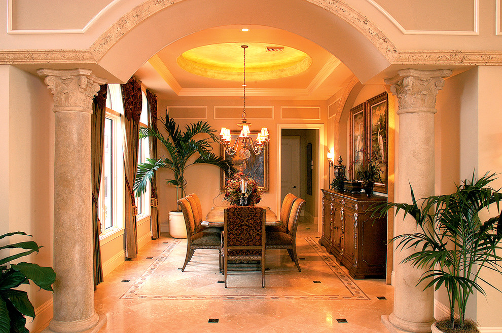 This is an example of a traditional separate dining room in Miami with beige walls and marble floors.