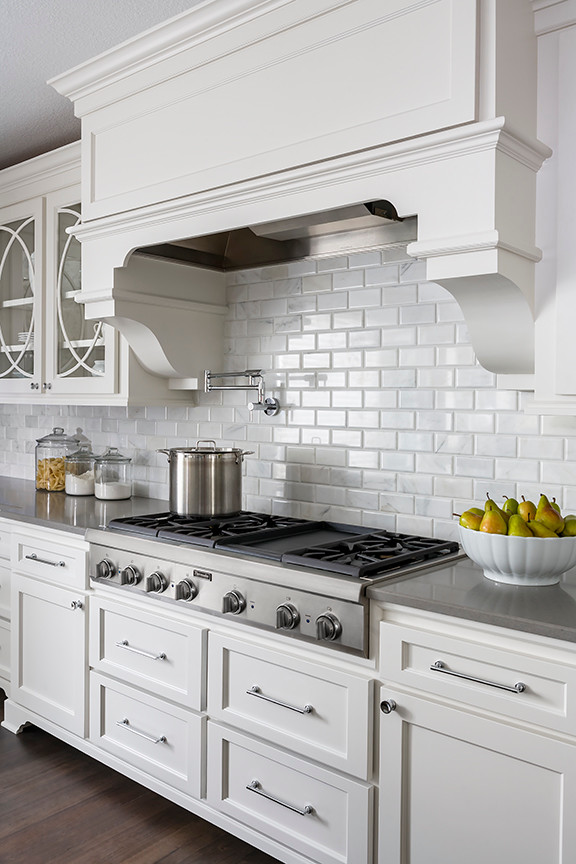 Example of a large transitional u-shaped dark wood floor eat-in kitchen design in Minneapolis with an undermount sink, recessed-panel cabinets, gray cabinets, marble countertops, white backsplash, stone tile backsplash, paneled appliances and two islands