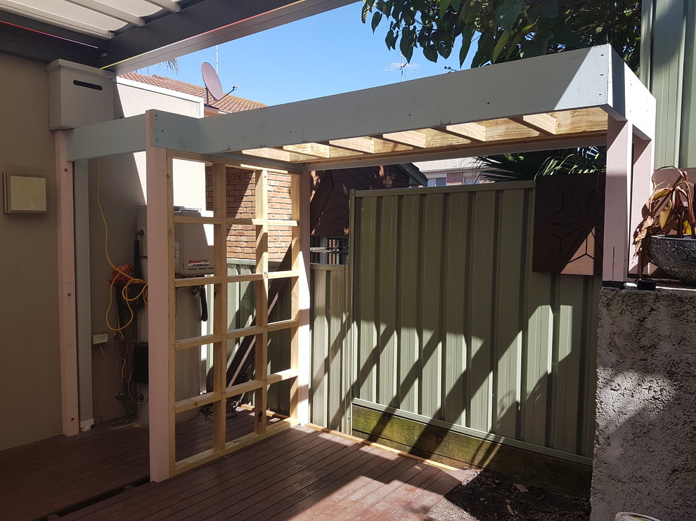 Photo of a mid-sized contemporary backyard deck in Melbourne with an outdoor kitchen and a pergola.