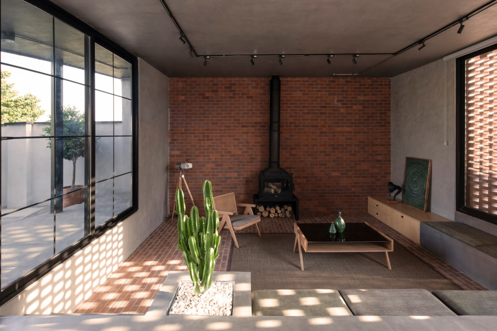 Inspiration for a mid-sized zen concrete floor and brick wall living room remodel in Other with brown walls