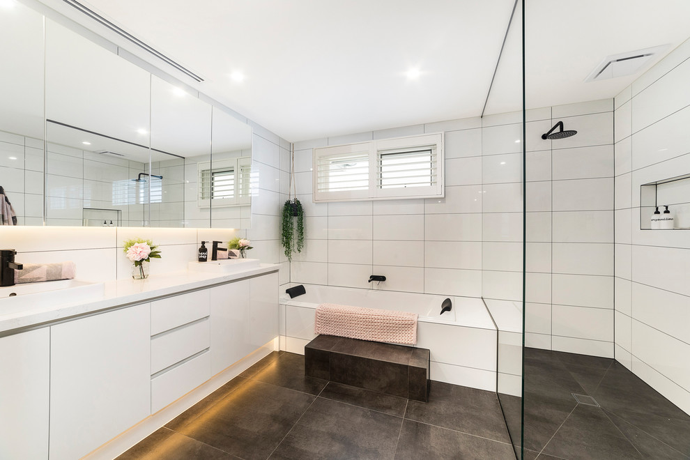 Design ideas for an expansive contemporary master bathroom in Melbourne with flat-panel cabinets, white cabinets, a drop-in tub, an open shower, white tile, ceramic tile, ceramic floors, grey floor, an open shower, white benchtops and a vessel sink.