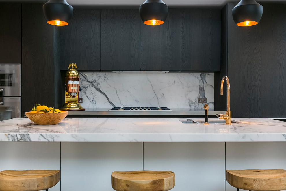This is an example of a contemporary kitchen in London with a double-bowl sink, flat-panel cabinets, dark wood cabinets, white splashback and stone slab splashback.
