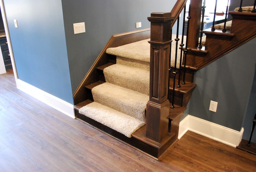 This is an example of a mid-sized arts and crafts wood l-shaped staircase in Cleveland with wood risers and metal railing.