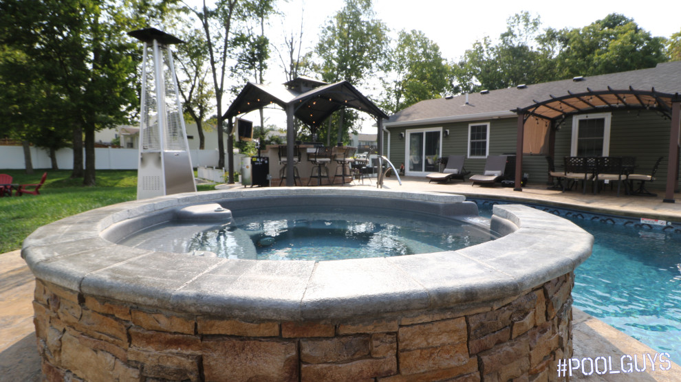 Pool - mid-sized mediterranean backyard stamped concrete and custom-shaped natural pool idea in Other