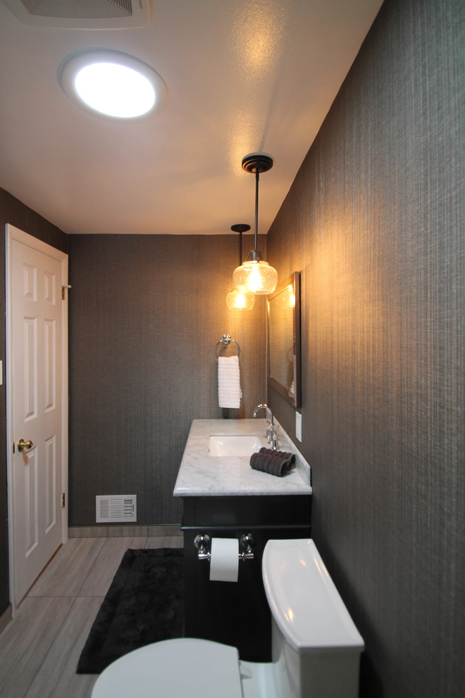 Inspiration for a mid-sized transitional gray tile and glass tile porcelain tile alcove bathtub remodel in Denver with shaker cabinets, gray cabinets, a one-piece toilet, gray walls, an undermount sink and marble countertops