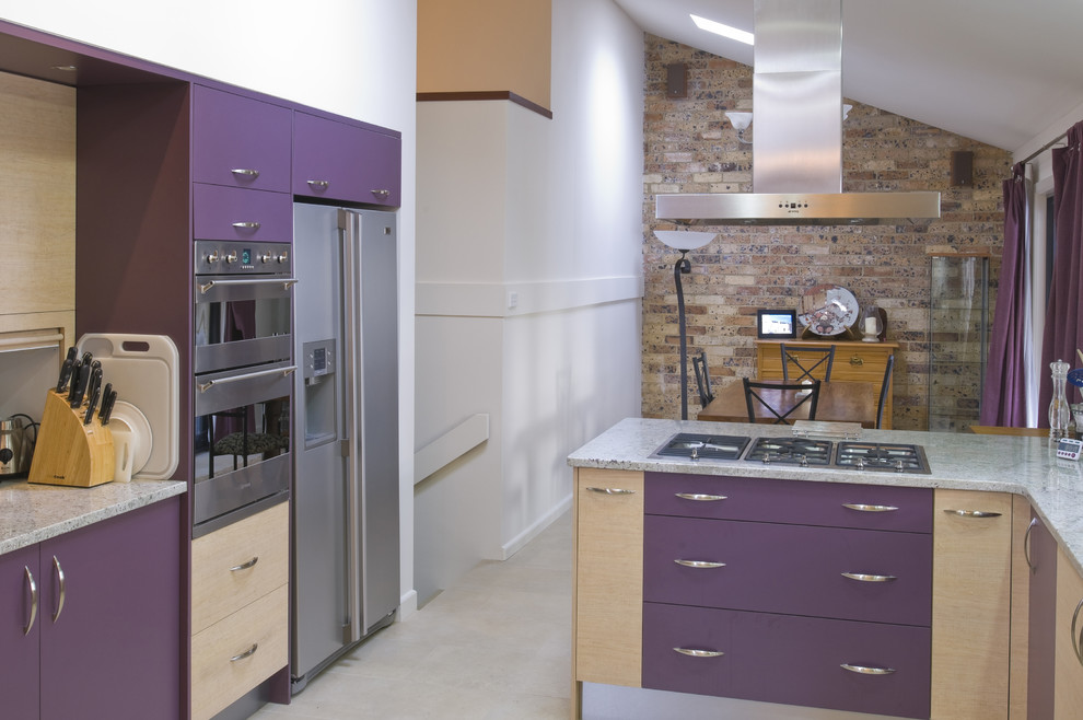 Mid-sized modern u-shaped open plan kitchen in Sydney with flat-panel cabinets, purple cabinets, granite benchtops, stainless steel appliances, ceramic floors, no island and beige floor.