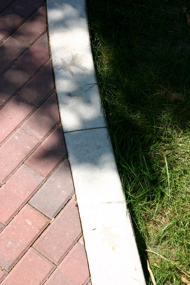 Mid-sized transitional backyard brick patio photo with no cover
