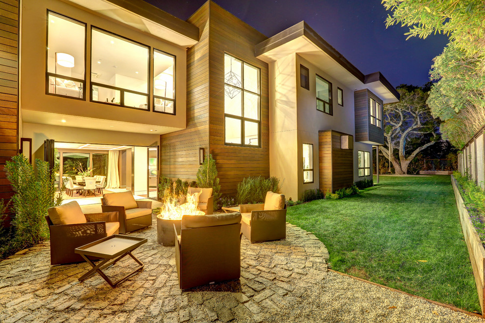 Large contemporary side yard patio in San Francisco with a fire feature, concrete pavers and no cover.