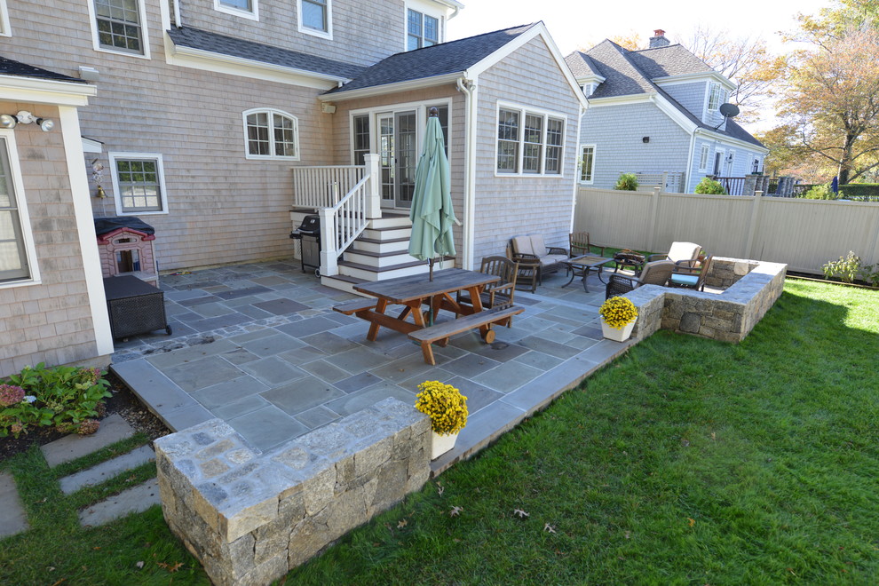 Photo of a large traditional backyard patio in New York with concrete pavers and no cover.