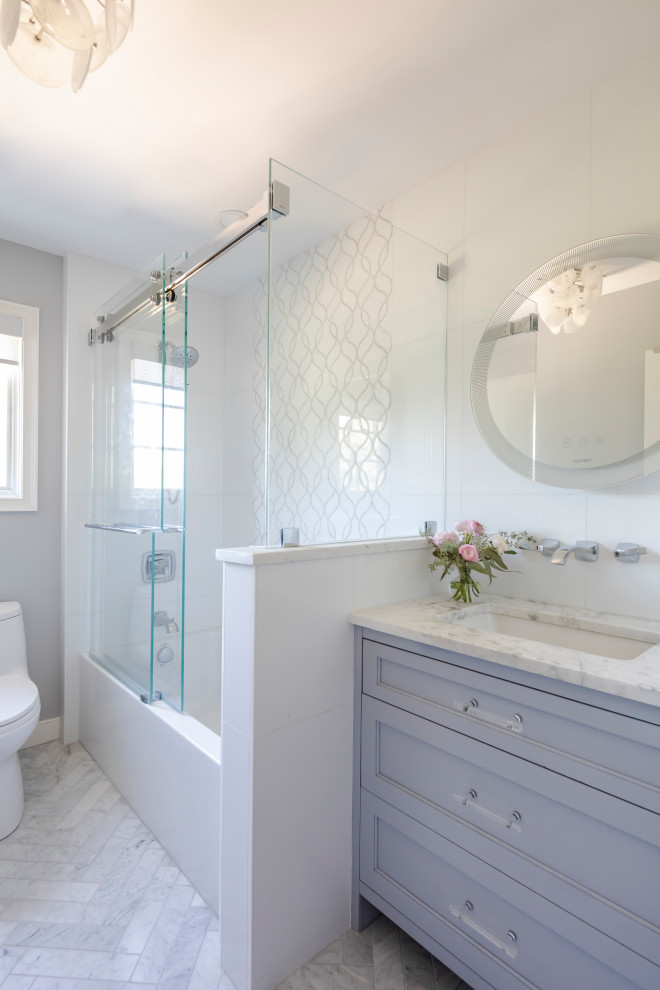 Inspiration for a small transitional kids bathroom in Bridgeport with furniture-like cabinets, grey cabinets, an alcove tub, a one-piece toilet, white tile, marble, marble floors, an undermount sink, marble benchtops, a sliding shower screen, white benchtops, a single vanity and a built-in vanity.