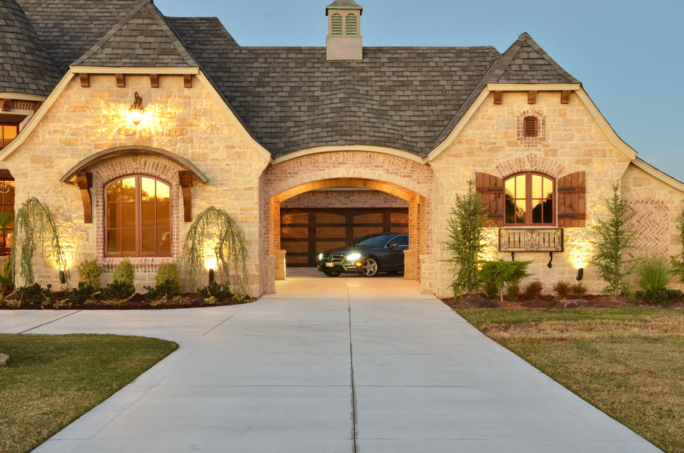 Photo of a large contemporary two-storey beige exterior in Oklahoma City with stone veneer.