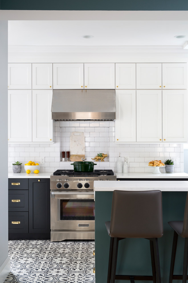 Example of a mid-sized transitional black floor eat-in kitchen design in DC Metro with black cabinets, white backsplash, subway tile backsplash and stainless steel appliances
