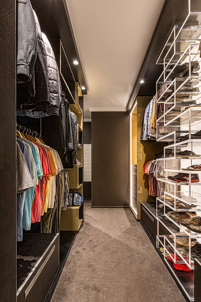 This is an example of a contemporary men's walk-in wardrobe in Los Angeles with open cabinets, carpet and grey floor.