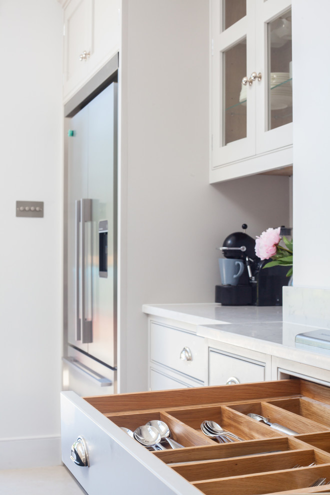 Photo of a large traditional kitchen in London with grey cabinets, quartzite benchtops and with island.