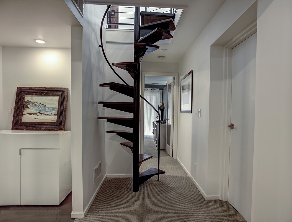 This is an example of a small midcentury wood spiral staircase in Grand Rapids.