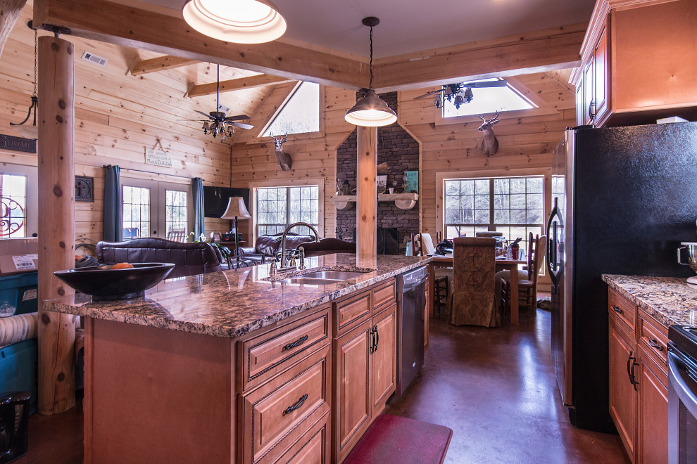 Example of a mid-sized mountain style galley eat-in kitchen design with an undermount sink, raised-panel cabinets, medium tone wood cabinets, granite countertops, wood backsplash, stainless steel appliances and an island