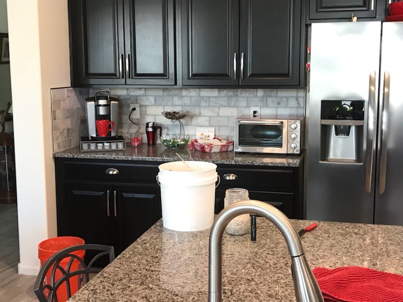 Eat-in kitchen - mid-sized modern single-wall eat-in kitchen idea in Phoenix with brown backsplash, brick backsplash, an island and white countertops