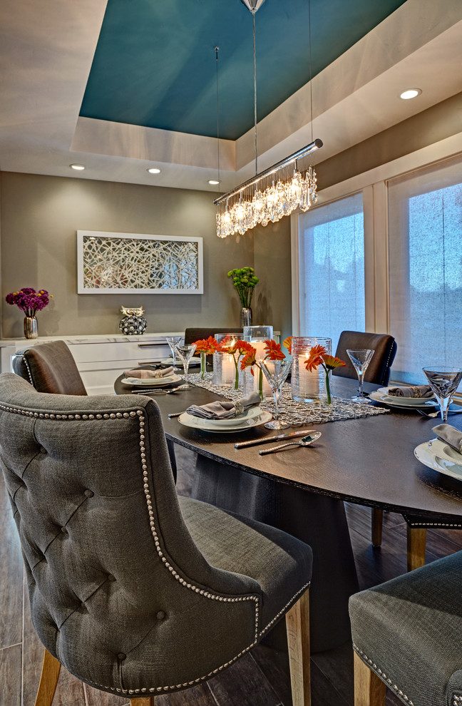 Photo of a mid-sized contemporary open plan dining in Sacramento with medium hardwood floors and grey walls.