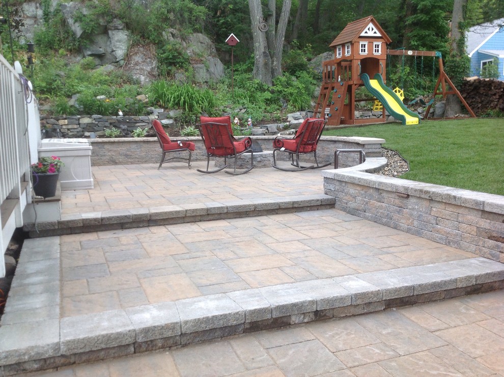 Design ideas for a mid-sized modern side yard patio in Boston with concrete pavers.