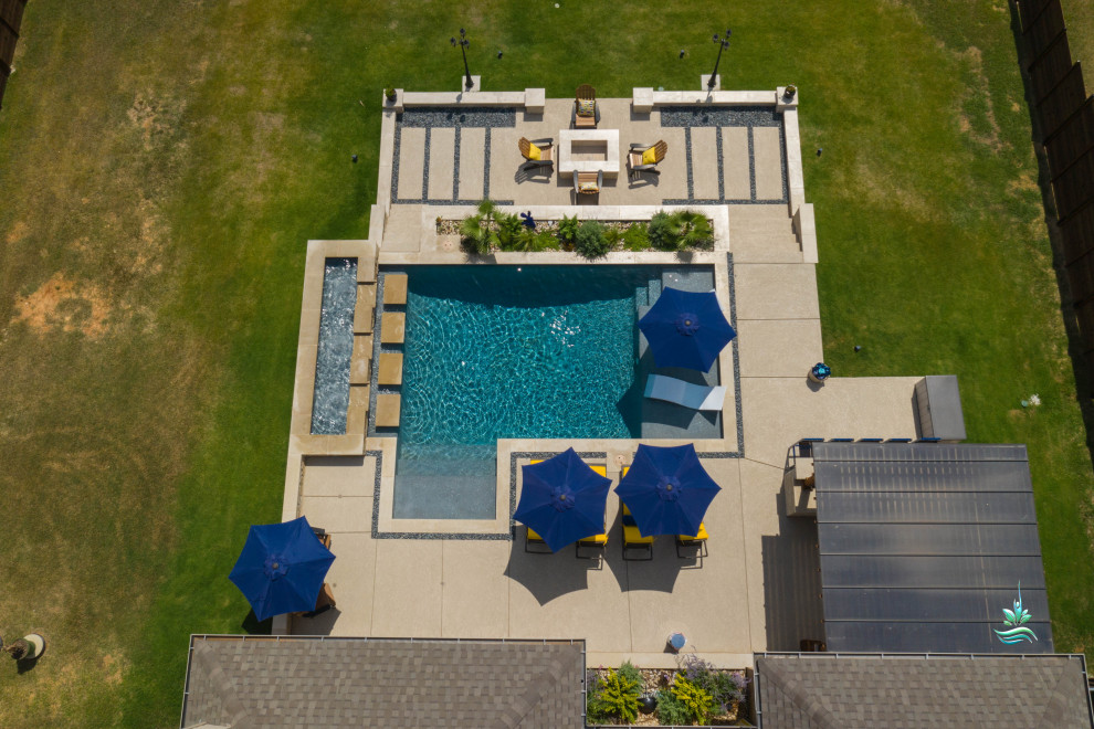Huge tuscan backyard custom-shaped infinity pool landscaping photo in Dallas with decking