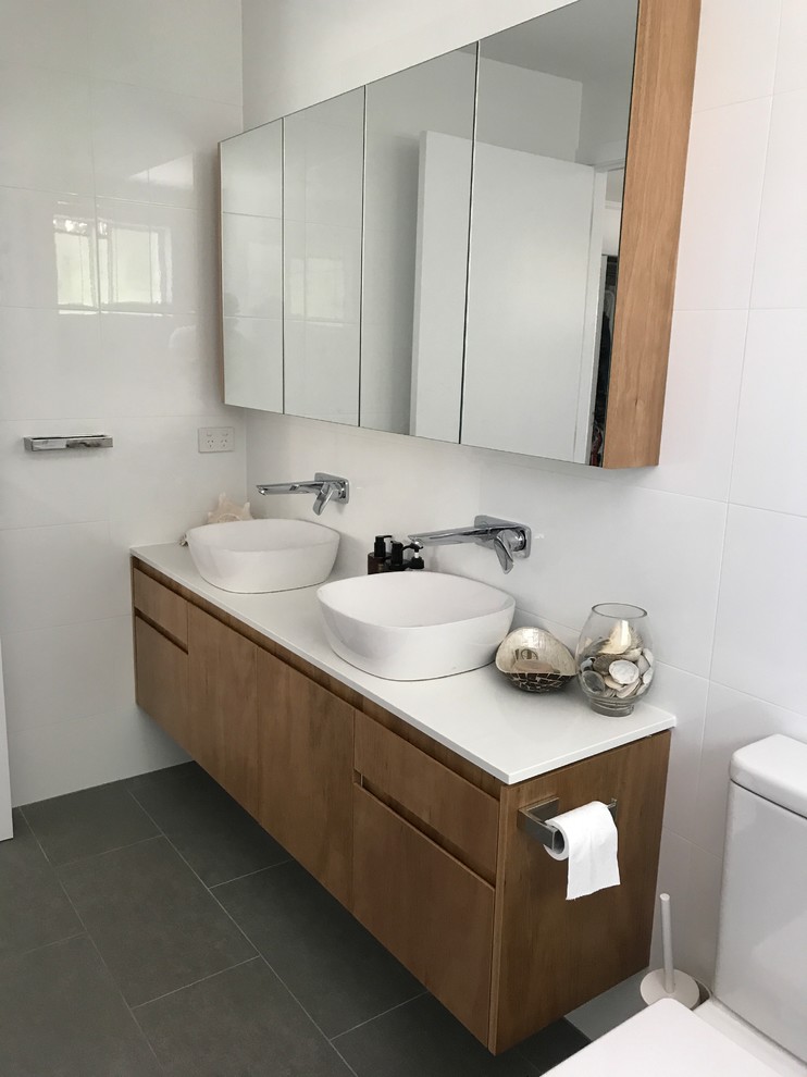 Design ideas for a mid-sized contemporary master bathroom with open cabinets, a freestanding tub, cement tile, beige walls, cement tiles, a vessel sink and grey floor.