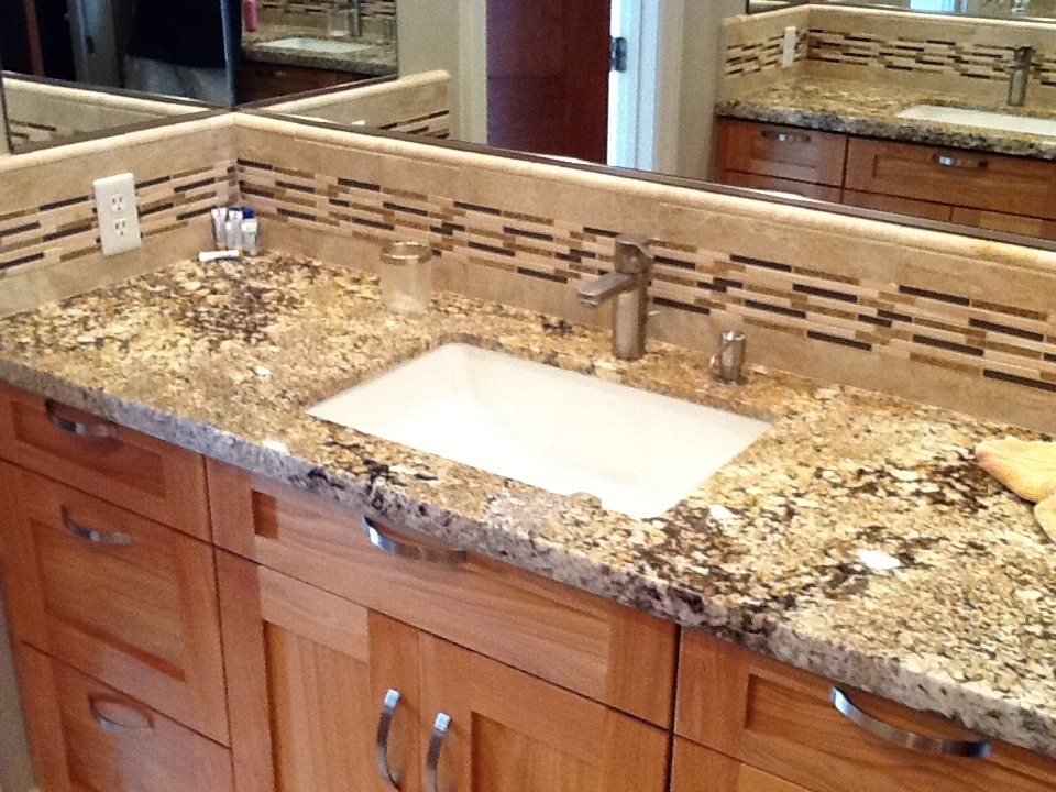 Inspiration for a kids' bathroom remodel with medium tone wood cabinets, granite countertops and a drop-in sink