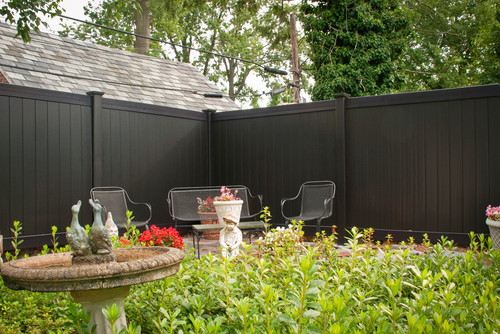 A black vinyl privacy fence with a simple contemporary design. This is an interesting take on a darker version of a fence, as typically homeowners choose a lighter color.
