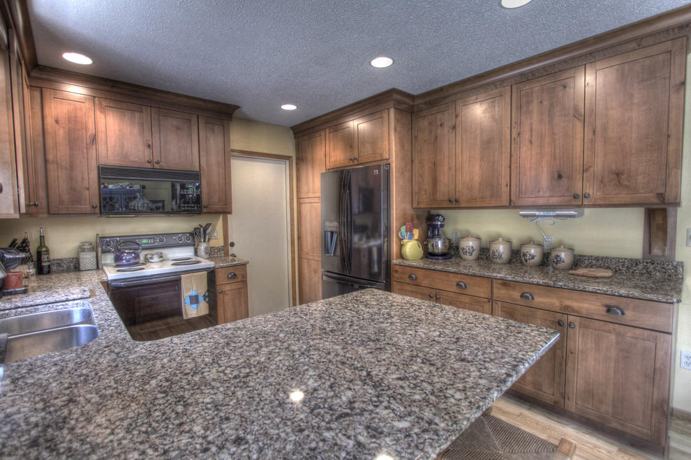 Inspiration for a rustic u-shaped eat-in kitchen remodel with an undermount sink, shaker cabinets, medium tone wood cabinets, quartz countertops and black appliances