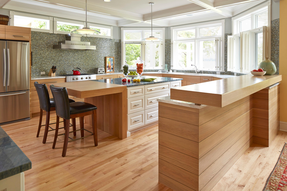 Design ideas for a transitional kitchen in Minneapolis with flat-panel cabinets, light wood cabinets, wood benchtops, multi-coloured splashback, mosaic tile splashback and stainless steel appliances.