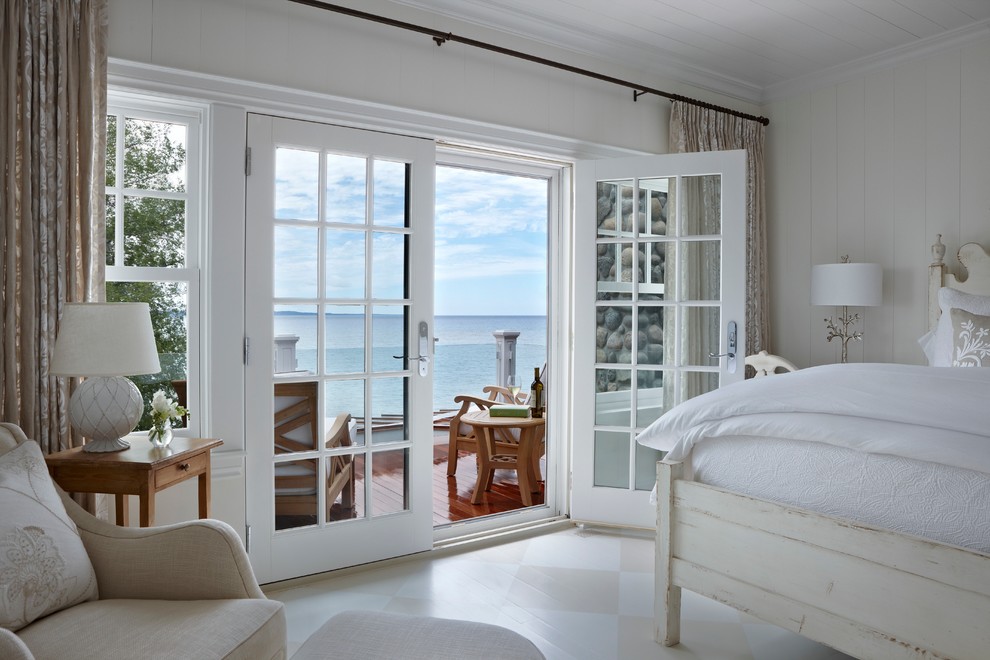 Design ideas for a beach style bedroom in Other with white walls, painted wood floors and multi-coloured floor.