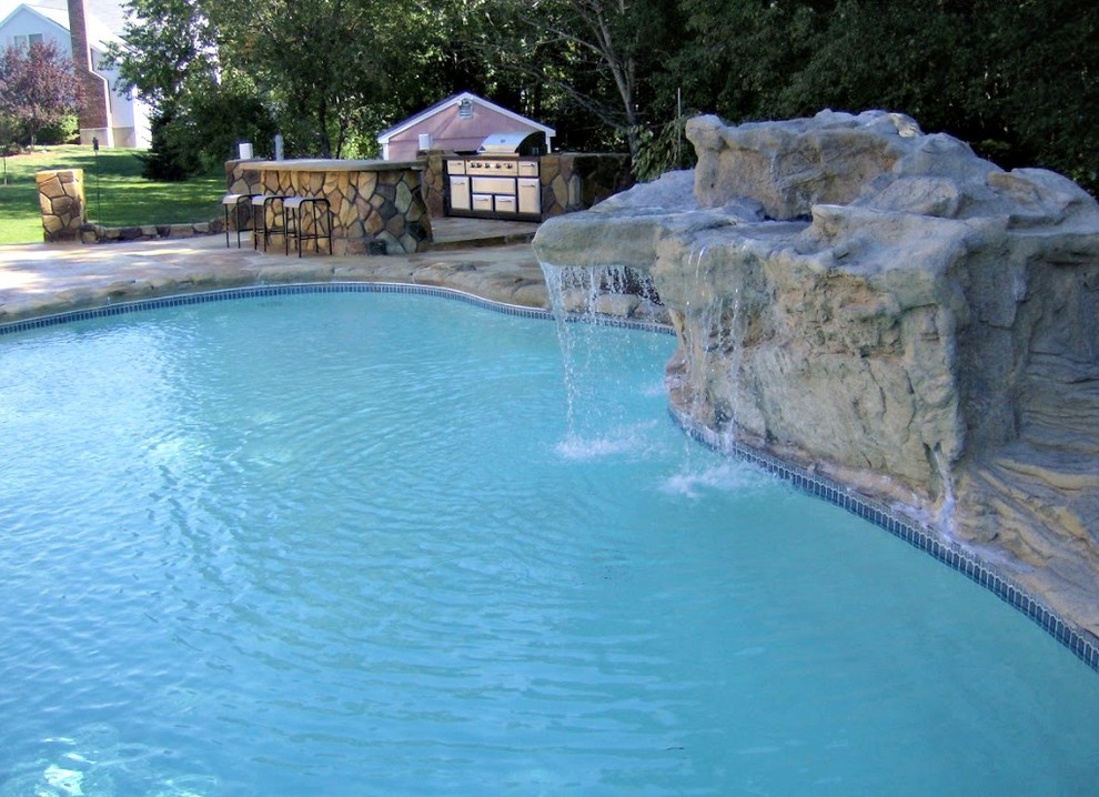 Inspiration for a large transitional backyard stone and custom-shaped lap pool fountain remodel in Boston